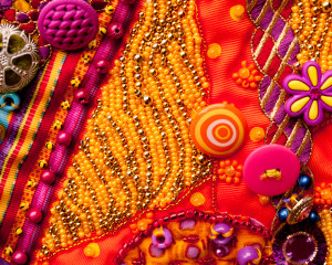 Background fabric entirely filled with yellow and gold beads.