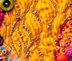 Bigger gold beads used to portray laughter